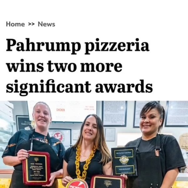Three smiling Mia Ava East Coast Pizza employees proudly display their two new awards.