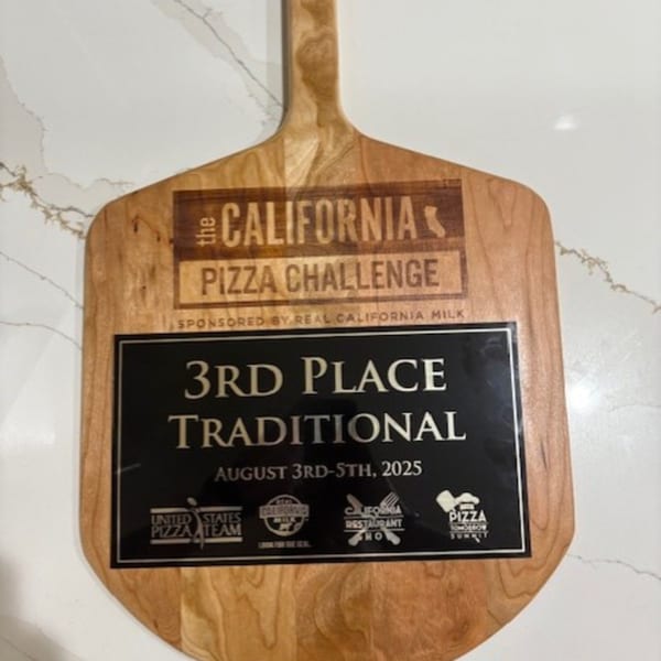 A wooden pizza peel award for 3rd Place Traditional at The California Pizza Challenge.
