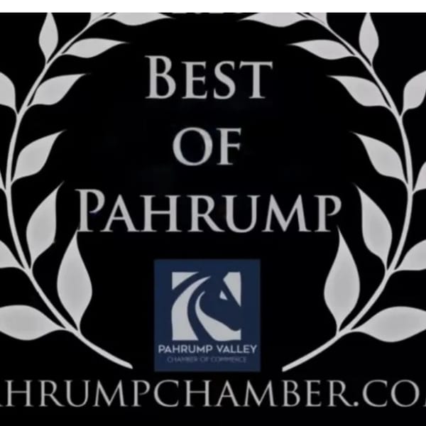 A black sign with white text reads "Best of Pahrump" with a laurel wreath and chamber of commerce logo.